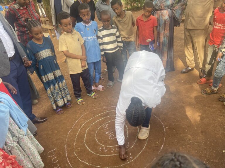 Children taking part in a group game at a community school