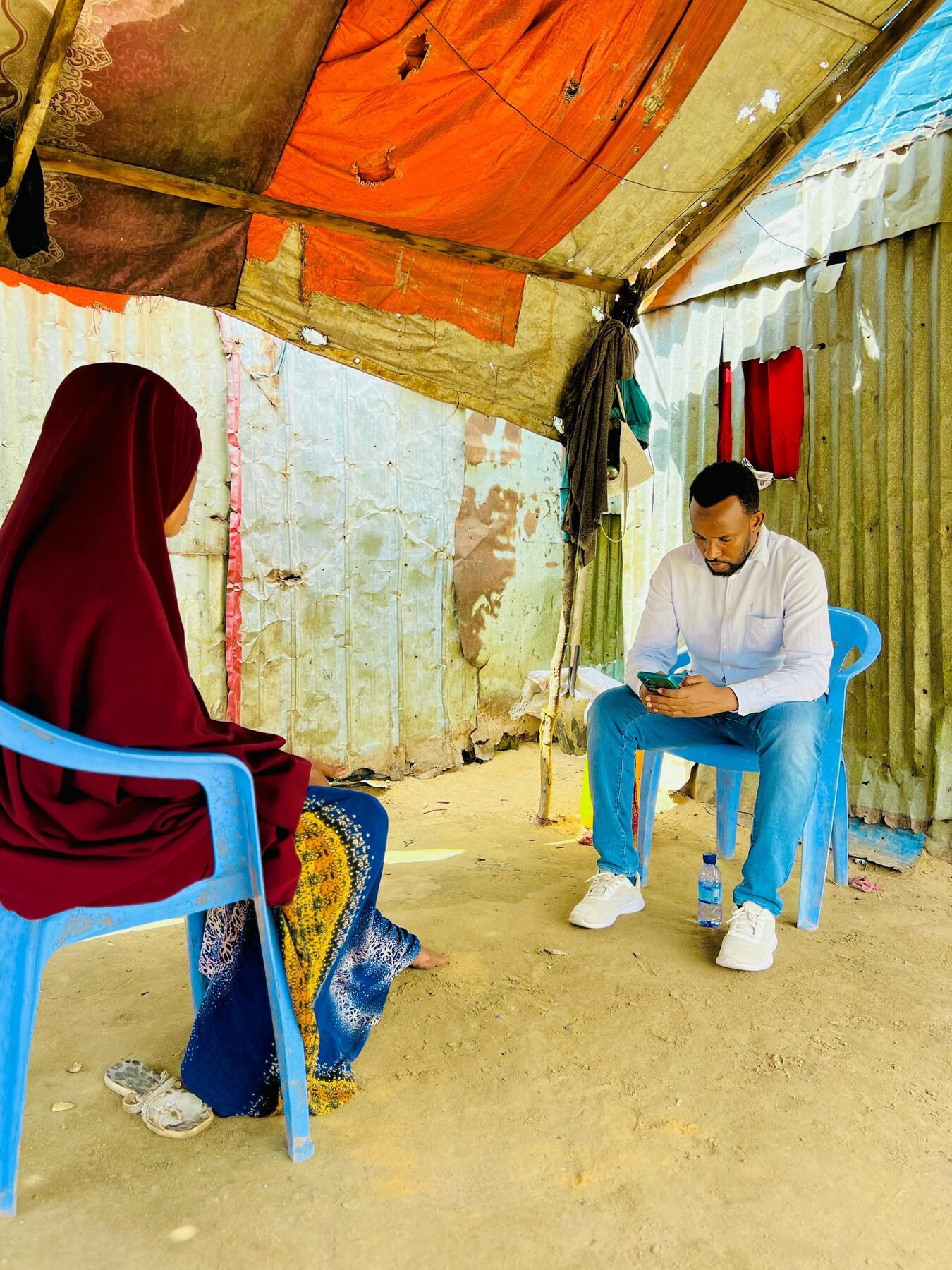 Enumerator recording responses on a tablet during a field assessment