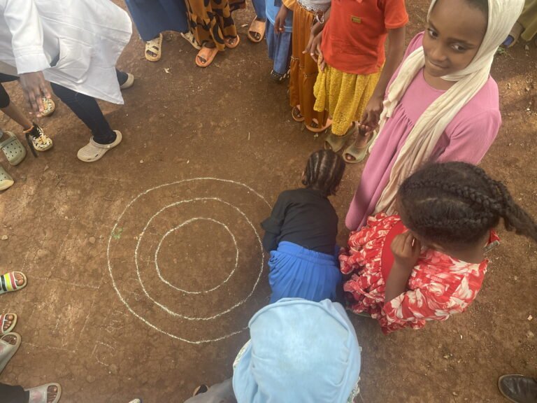 Children playing a traditional circle game in a school yard