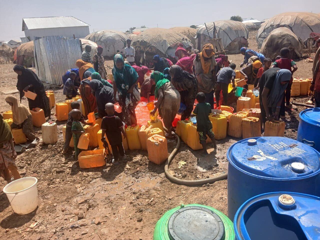 Families waiting to collect water