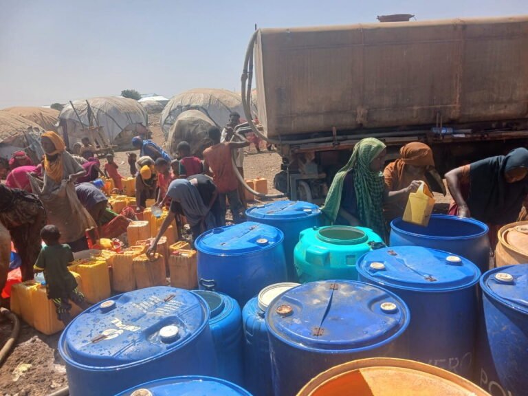 Water storage drums and jerrycans at a distribution site